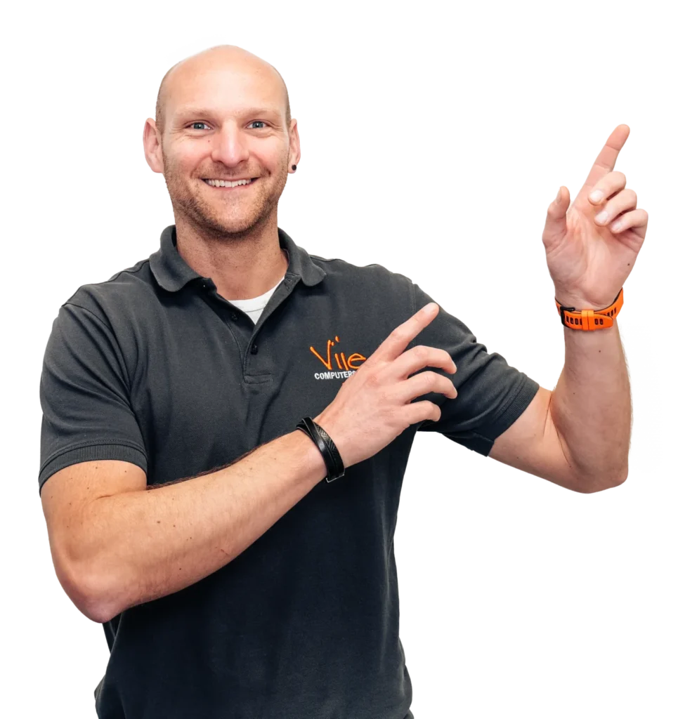 Vije-Mitarbeiter im dunkelgrauen Poloshirt zeigt lächelnd auf das Beratungsangebot.